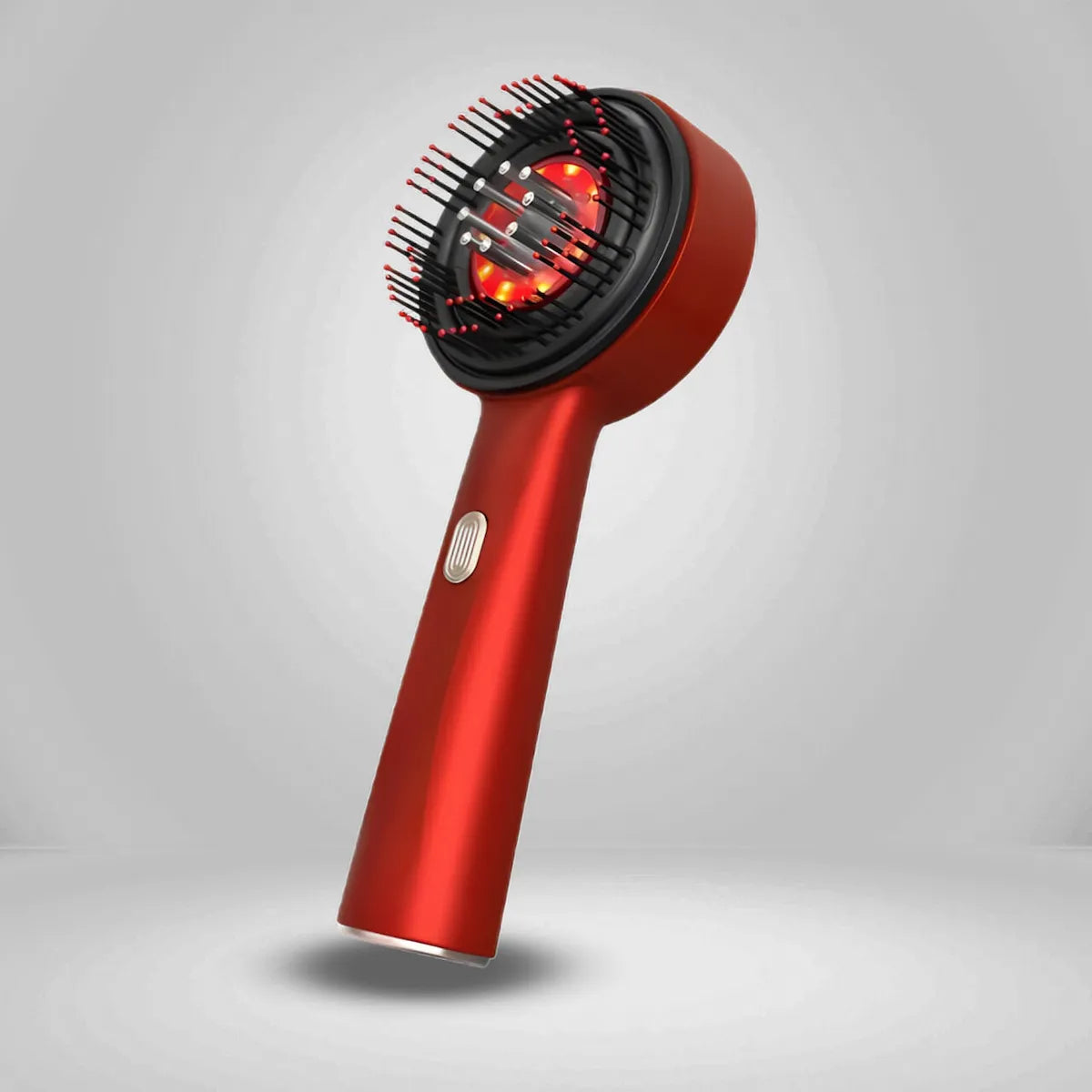 Red comb with a black brush attachment on a gray background